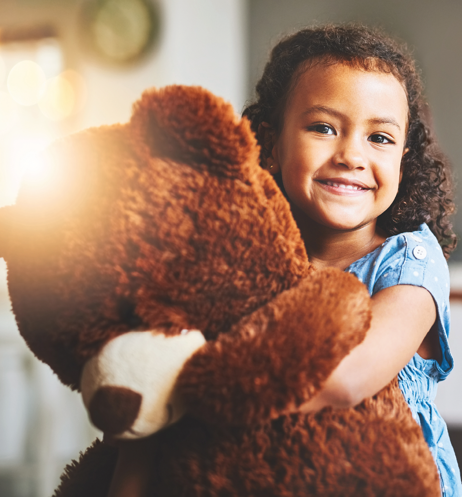 Little girl hugging a bear