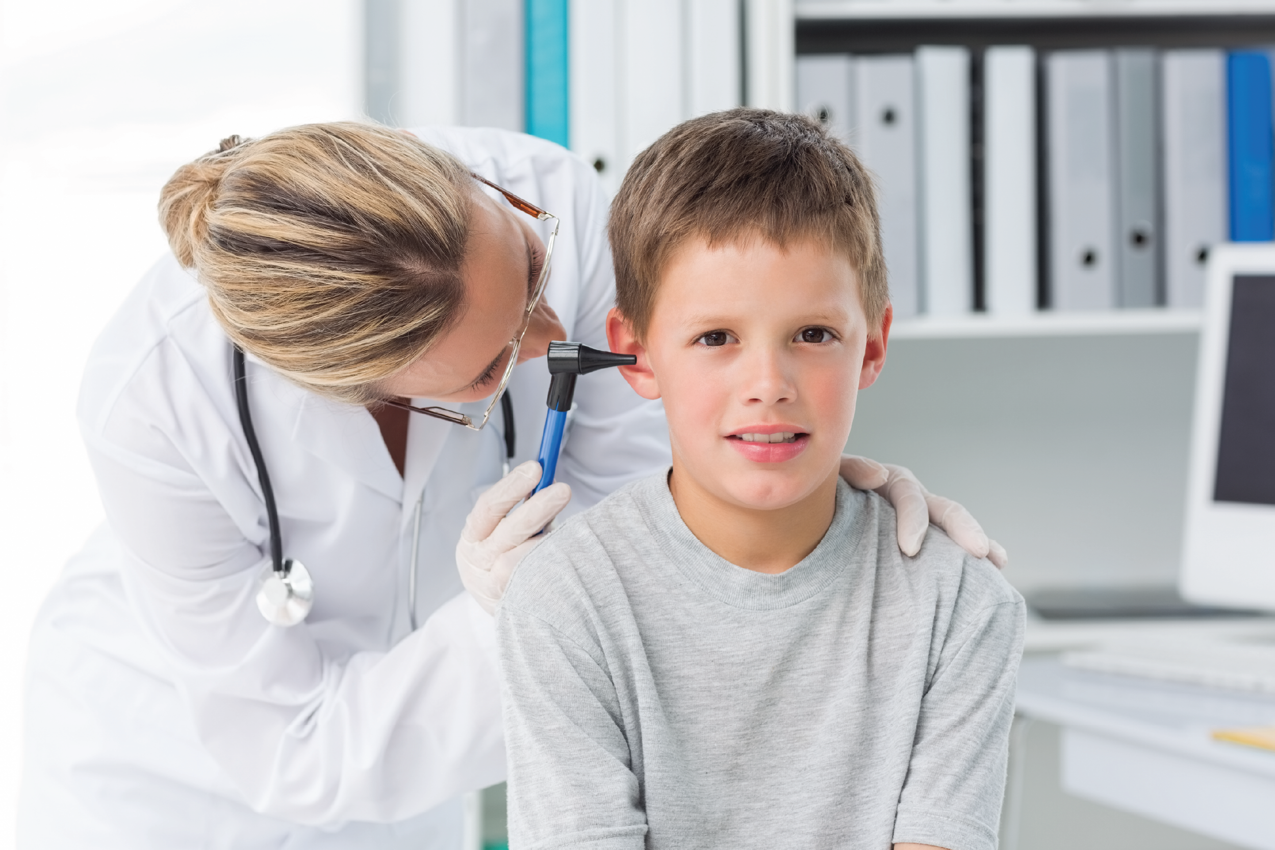 Doctor checking child's ears
