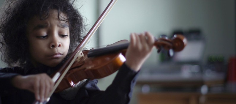 Caesar Sant practicing his violin