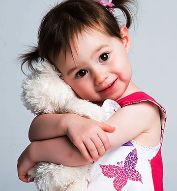 Little girl hugging a bear