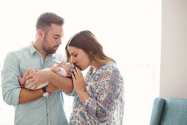 Mom and dad holding new baby