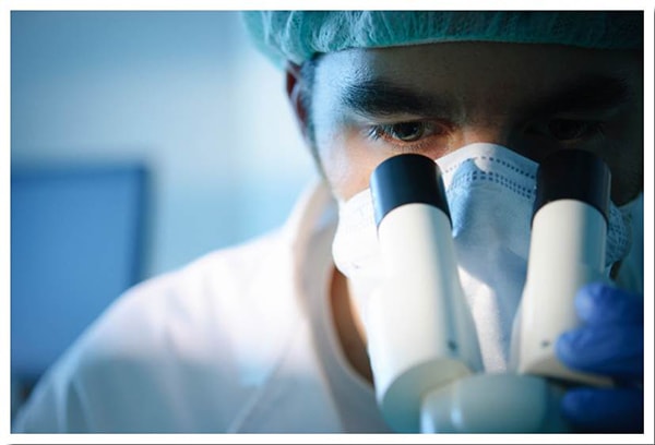 Technician with microscope